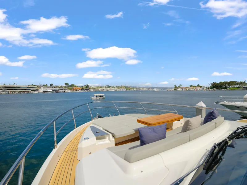 Slide: The Image of 2024 Absolute 60 Fly yacht with spacious deck and scenic waterfront view. - 10