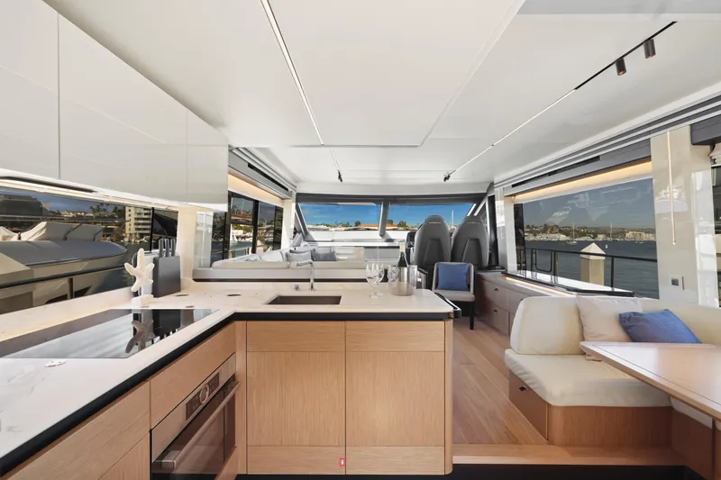 Slide: The Image of Luxurious interior of the 2024 Absolute 60 Fly yacht with modern kitchen and seating area. - 31