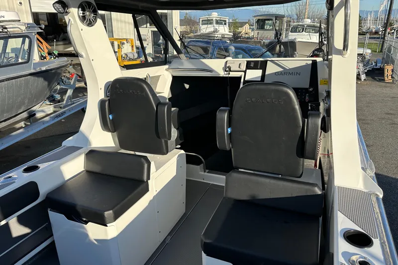Slide: The Image of 2026 Sealegs 8.5m Cabin interior with Garmin navigation system and black seating. - 13