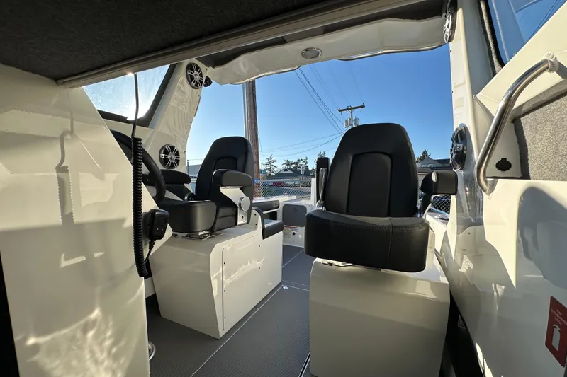 Slide: The Image of Interior of 2026 Sealegs 8.5m Cabin boat with black seats and modern design. - 14