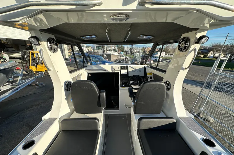 Slide: The Image of Interior view of 2026 Sealegs 8.5m Cabin boat with modern dashboard and seating. - 8