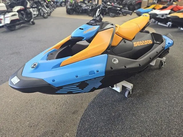 Slide: The Image of 2026 Sea-Doo Spark Trixx for 3, blue-orange jet ski in showroom. - 4