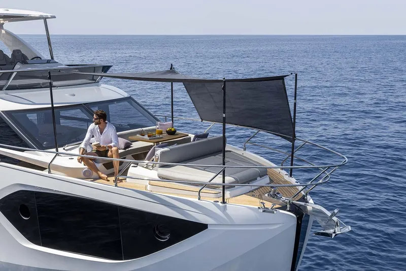 Slide: The Image of Man relaxing on 2026 Absolute 52 FLY yacht, enjoying ocean view. - 11