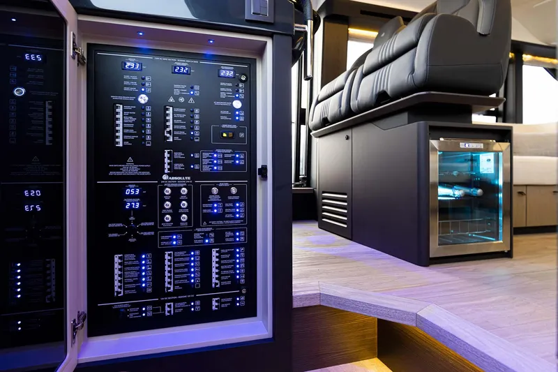 Slide: The Image of Electrical panel and seating area inside 2026 Absolute 52 FLY yacht, featuring modern design elements. - 19