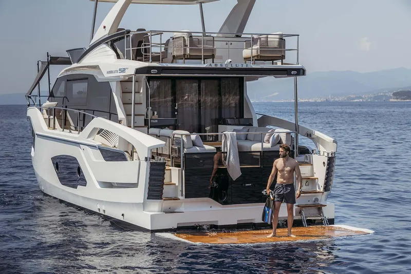 Slide: The Image of Luxury Absolute 52 FLY yacht, 2026 model, with people enjoying the sea. - 31