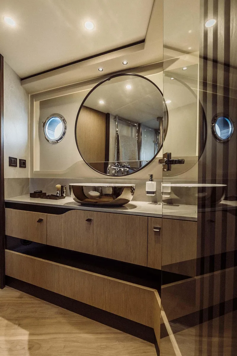 Slide: The Image of Luxurious bathroom in 2026 Absolute 52 FLY yacht with modern fixtures and round mirror. - 40