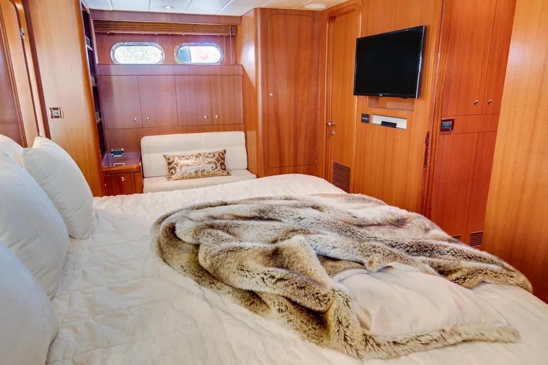 Slide: The Image of Luxurious bedroom interior of 2008 Horizon 82 Cockpit Motoryacht with wood paneling and plush bedding. - 21