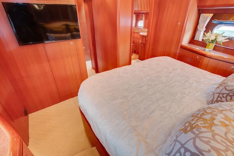 Slide: The Image of Luxurious bedroom interior of 2008 Horizon 82 Cockpit Motoryacht with elegant wood paneling. - 25
