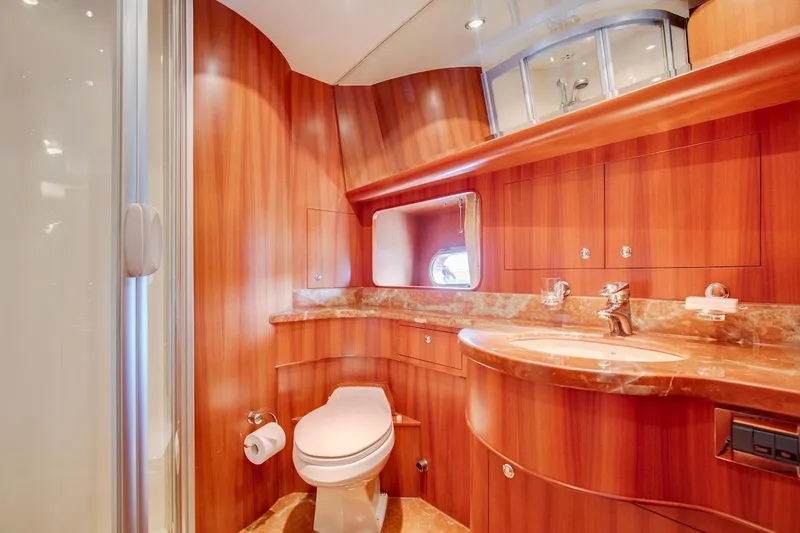 Slide: The Image of Luxurious bathroom in 2008 Horizon 82 Cockpit Motoryacht with wood paneling and marble countertop. - 26