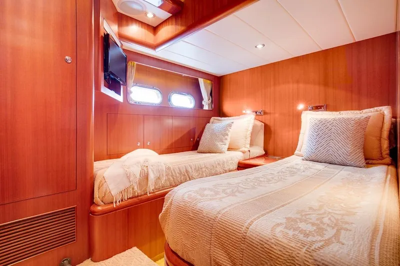 Slide: The Image of Luxurious cabin interior of 2008 Horizon 82 Cockpit Motoryacht with twin beds and wood paneling. - 27