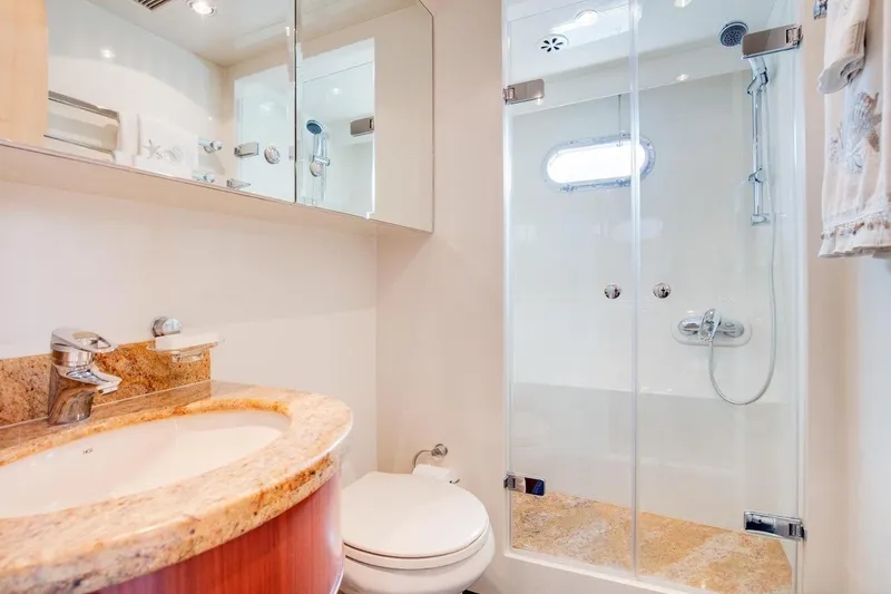 Slide: The Image of Luxurious bathroom in 2008 Horizon 82 Cockpit Motoryacht with granite countertop and glass shower. - 33