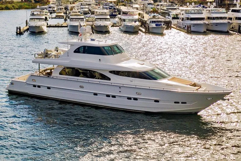 Slide: The Image of Luxurious 2008 Horizon 82 Cockpit Motoryacht cruising in a marina with multiple yachts. - 5