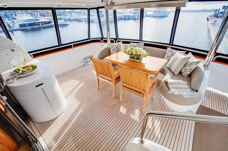 Slide: The Image of Luxurious 2008 Horizon 82 Cockpit Motoryacht interior with elegant seating and scenic marina view. - 8