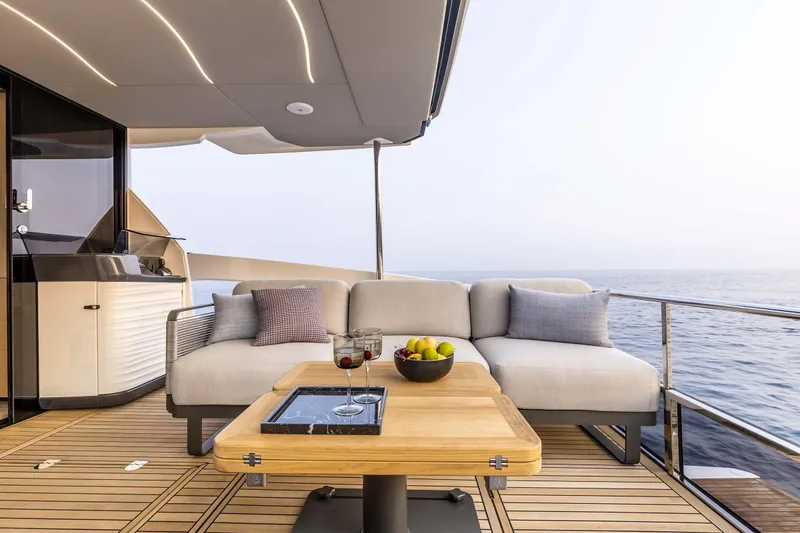 Slide: The Image of Luxurious deck of 2026 Absolute 52 FLY yacht with ocean view and elegant seating. - 11