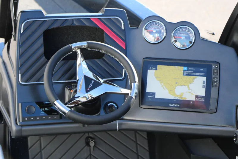 Slide: The Image of 2025 Vexus DVX 20S boat dashboard with steering wheel, gauges, and Garmin navigation display. - 16