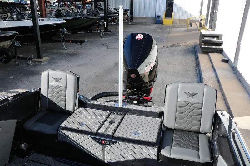 Slide: The Image of 2025 Vexus DVX 20S boat interior with seating and motor in a showroom. - 28