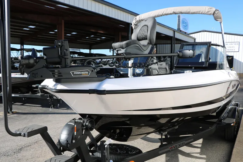 Slide: The Image of 2025 Vexus DVX 20S boat with Minn Kota motor, parked in a marina setting. - 5