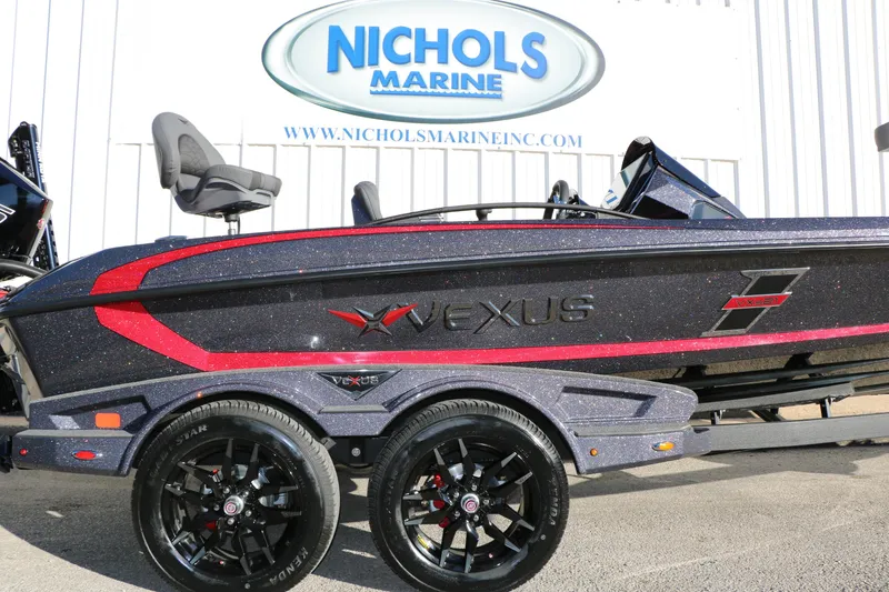 Slide: The Image of 2026 Vexus VXs21 boat at Nichols Marine dealership, featuring sleek design and vibrant colors. - 11