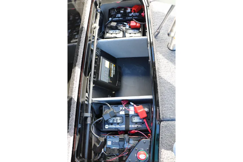 Slide: The Image of 2026 Vexus VXs21 boat battery compartment with multiple batteries and wiring. - 43