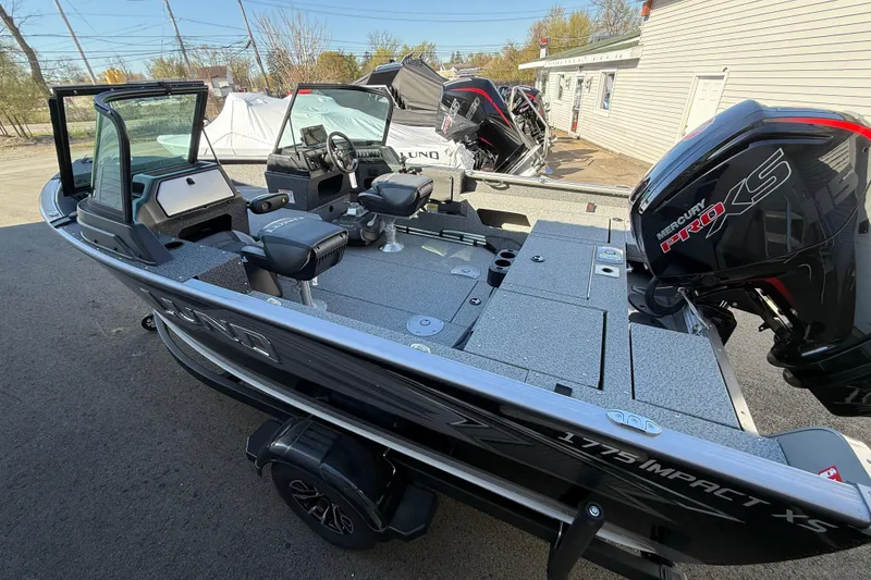 Slide: The Image of 2026 Lund 1775 Impact XS Sport boat with Mercury Pro XS engine, parked outdoors. - 3
