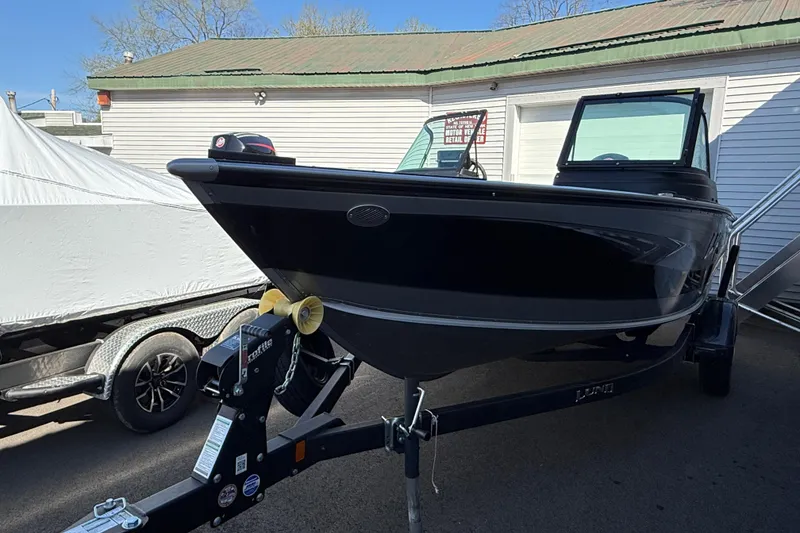Slide: The Image of 2026 Lund 1775 Impact XS Sport boat on trailer, parked outdoors. - 4