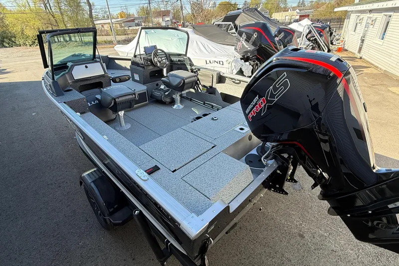 Slide: The Image of 2026 Lund 1775 Impact XS Sport boat with Mercury Pro XS engine, parked outdoors. - 6