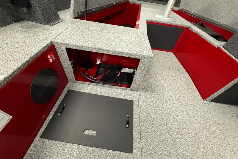 Slide: The Image of 2026 Lund 1700 Explorer SS boat interior with storage compartments and red accents. - 10