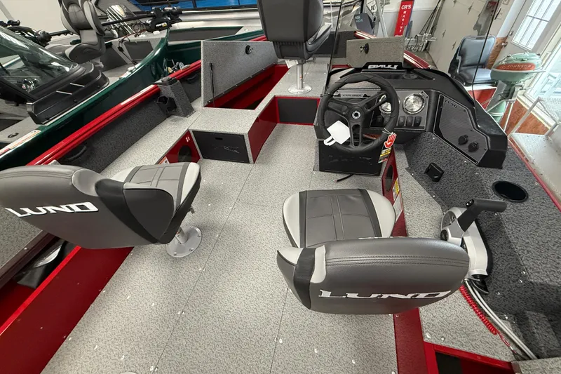 Slide: The Image of 2026 Lund 1700 Explorer SS boat interior with steering console and seating. - 11
