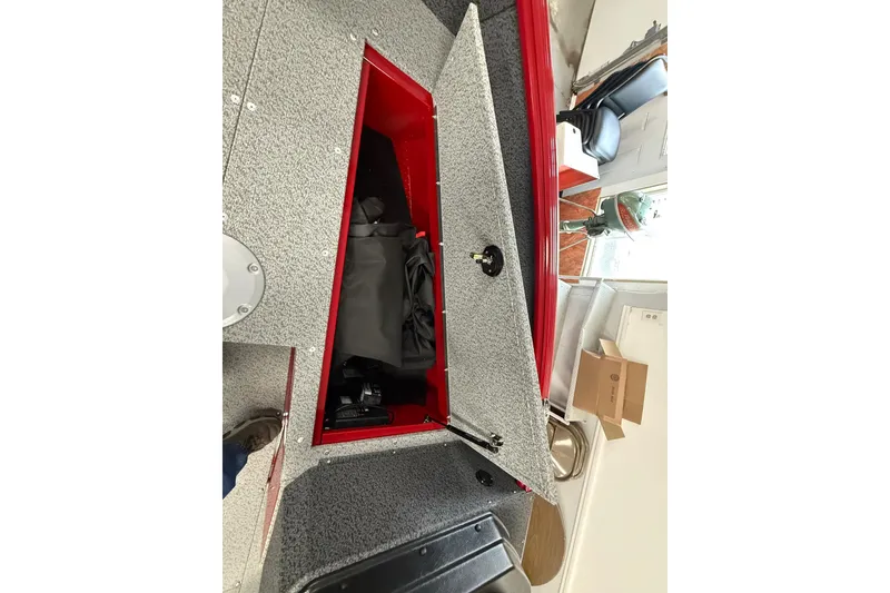 Slide: The Image of Open storage compartment in 2026 Lund 1700 Explorer SS boat, showcasing interior space. - 3