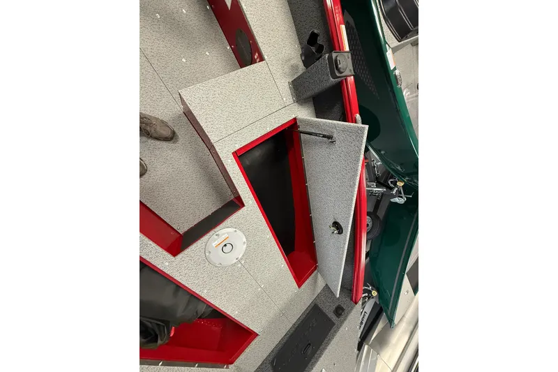 Slide: The Image of 2026 Lund 1700 Explorer SS boat interior with open storage compartments and gray-red design. - 4