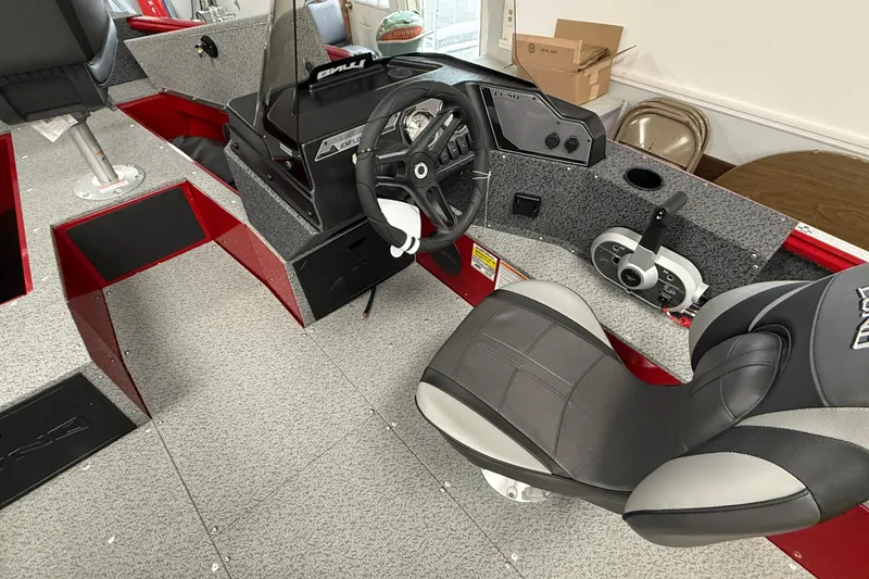 Slide: The Image of 2026 Lund 1700 Explorer SS boat interior with steering wheel and seating. - 6