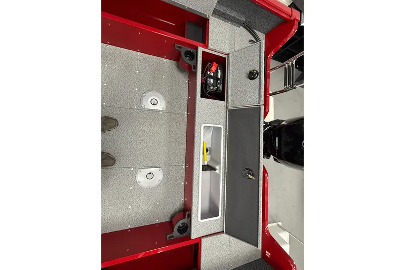 Slide: The Image of 2026 Lund 1700 Explorer SS boat interior with storage compartments and battery setup. - 7