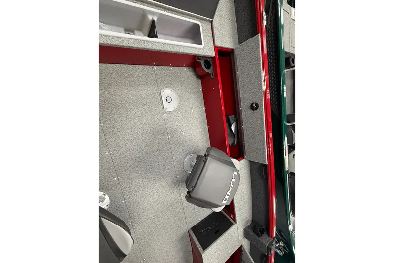 Slide: The Image of 2026 Lund 1700 Explorer SS boat interior with storage compartments and seating. - 9