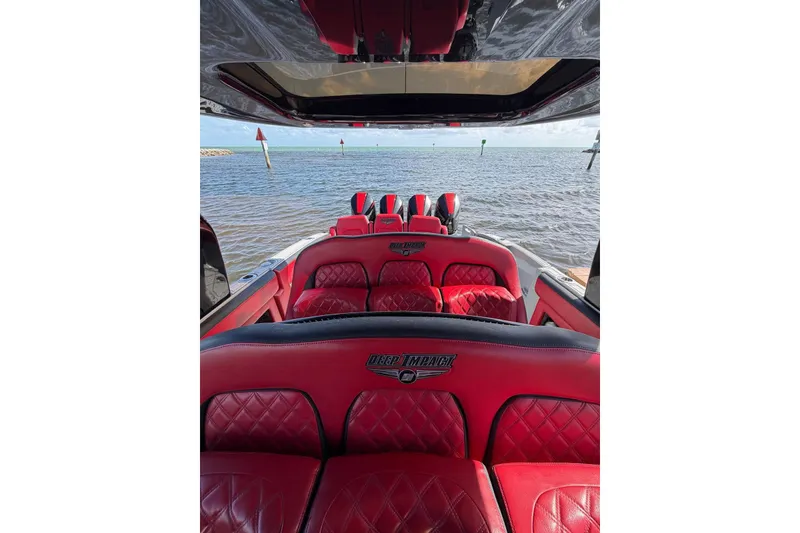 Slide: The Image of 2020 Deep Impact 399 Sport boat with luxurious red interior on open water. - 11