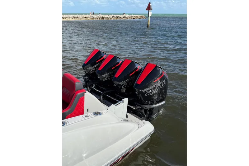 Slide: The Image of Four powerful outboard motors on a 2020 Deep Impact 399 Sport boat in the water. - 15
