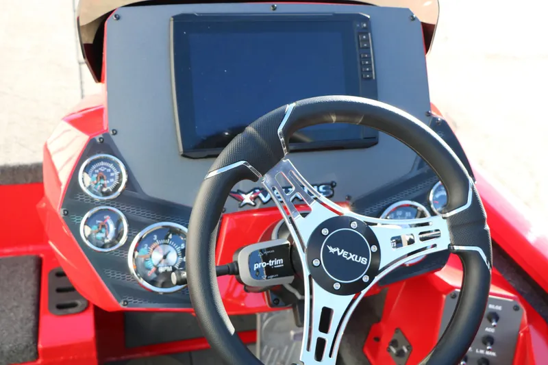 Slide: The Image of 2026 Vexus AVX 2080 boat dashboard with steering wheel and digital display. - 32