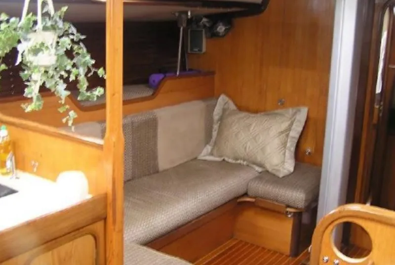 Slide: The Image of Interior of a 1985 Beneteau First 42 yacht with cozy seating area. - 21