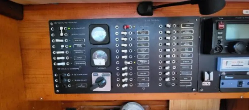 Slide: The Image of Beneteau First 42 control panel, 1985 model, featuring various switches and gauges. - 27