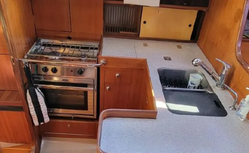 Slide: The Image of Galley area of a 1985 Beneteau First 42 yacht with stove and sink. - 29