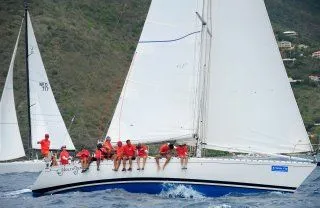 Slide: The Image of 1985 Beneteau First 42 sailboat with crew on the water. - 40