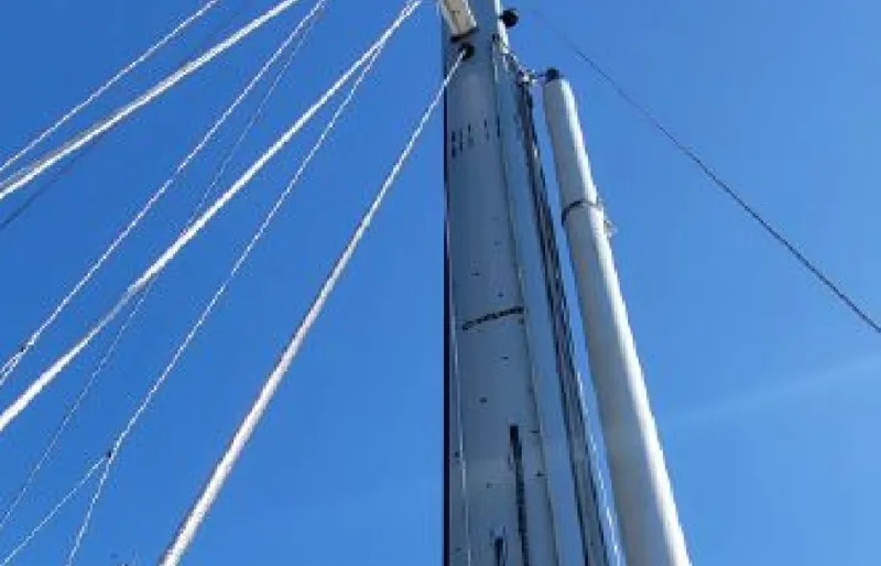 Slide: The Image of Mast of a 1985 Beneteau First 42 sailboat against blue sky. - 6