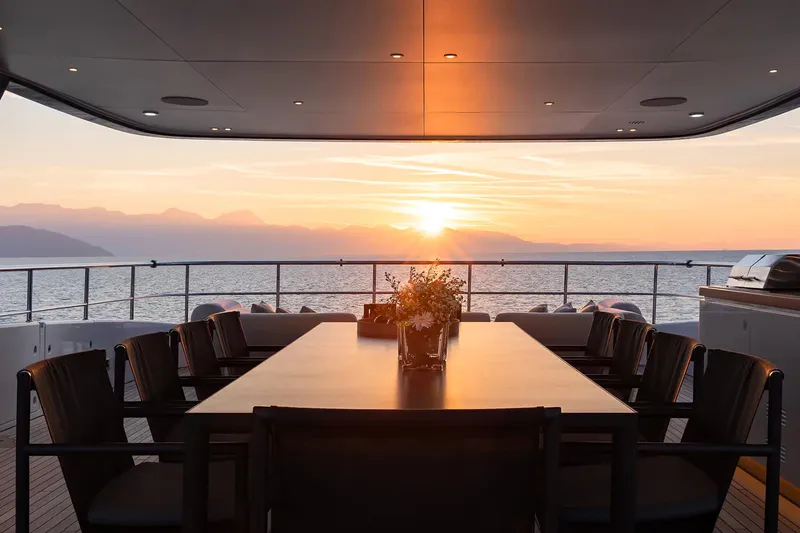 Slide: The Image of Luxurious Benetti Oasis 34M yacht deck with sunset view, 2023 model. - 10
