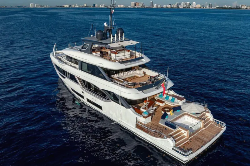 Slide: The Image of Luxurious 2023 Benetti Oasis 34M yacht cruising on open sea near city skyline. - 12