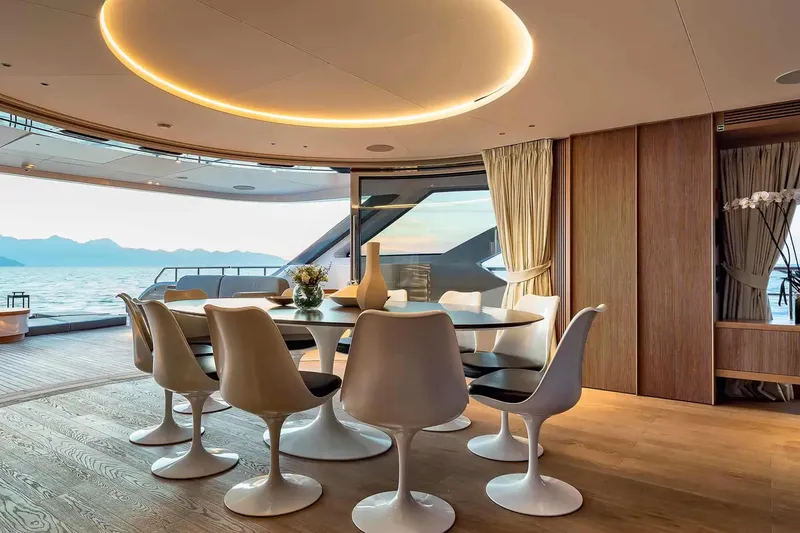 Slide: The Image of Luxurious dining area on 2023 Benetti Oasis 34M yacht, featuring elegant seating and ocean views. - 16