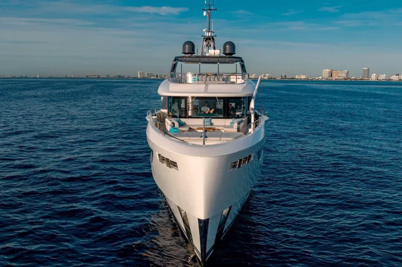 Slide: The Image of 2023 Benetti Oasis 34M Co Ownership yacht on open sea, city skyline in background. - 3