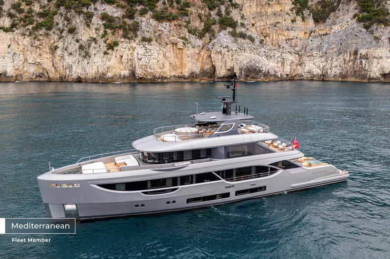 Slide: The Image of 2023 Benetti Oasis 34M yacht cruising in Mediterranean waters near rocky cliffs. - 48