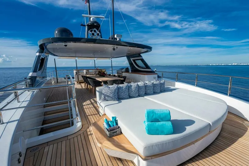 Slide: The Image of Luxurious 2023 Benetti Oasis 34M yacht deck with seating, ocean view, and blue sky. - 8