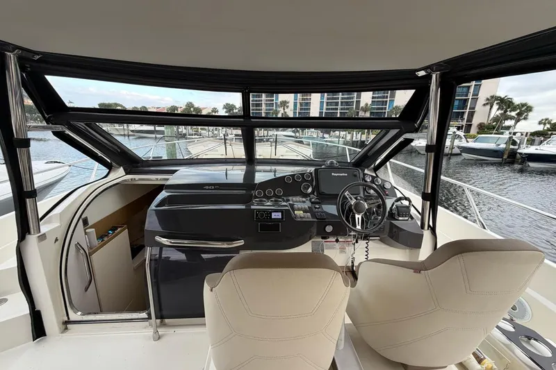 Slide: The Image of 2019 Absolute 40 SLT yacht cruising on a scenic waterway with palm trees. - 0