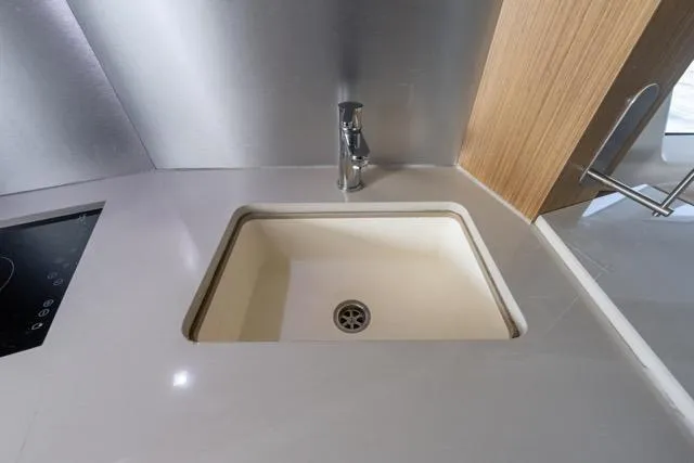 Slide: The Image of Modern kitchen sink in 2019 Absolute 40 SLT yacht, featuring sleek design and stainless steel faucet. - 31