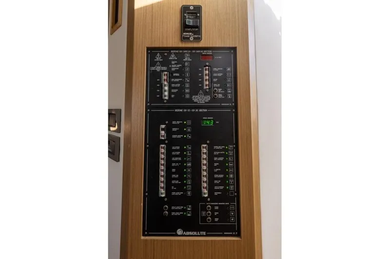 Slide: The Image of Electrical control panel on 2019 Absolute 40 SLT yacht, featuring various switches and indicators. - 35
